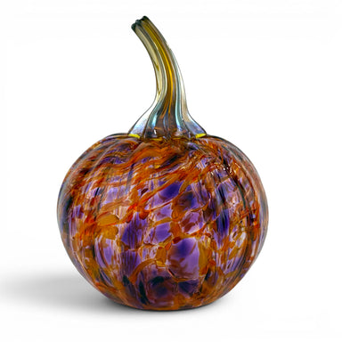 A hand-blown glass pumpkin sculpture with a curved stem, featuring a marbled pattern of purple, orange, and amber tones on a white background.