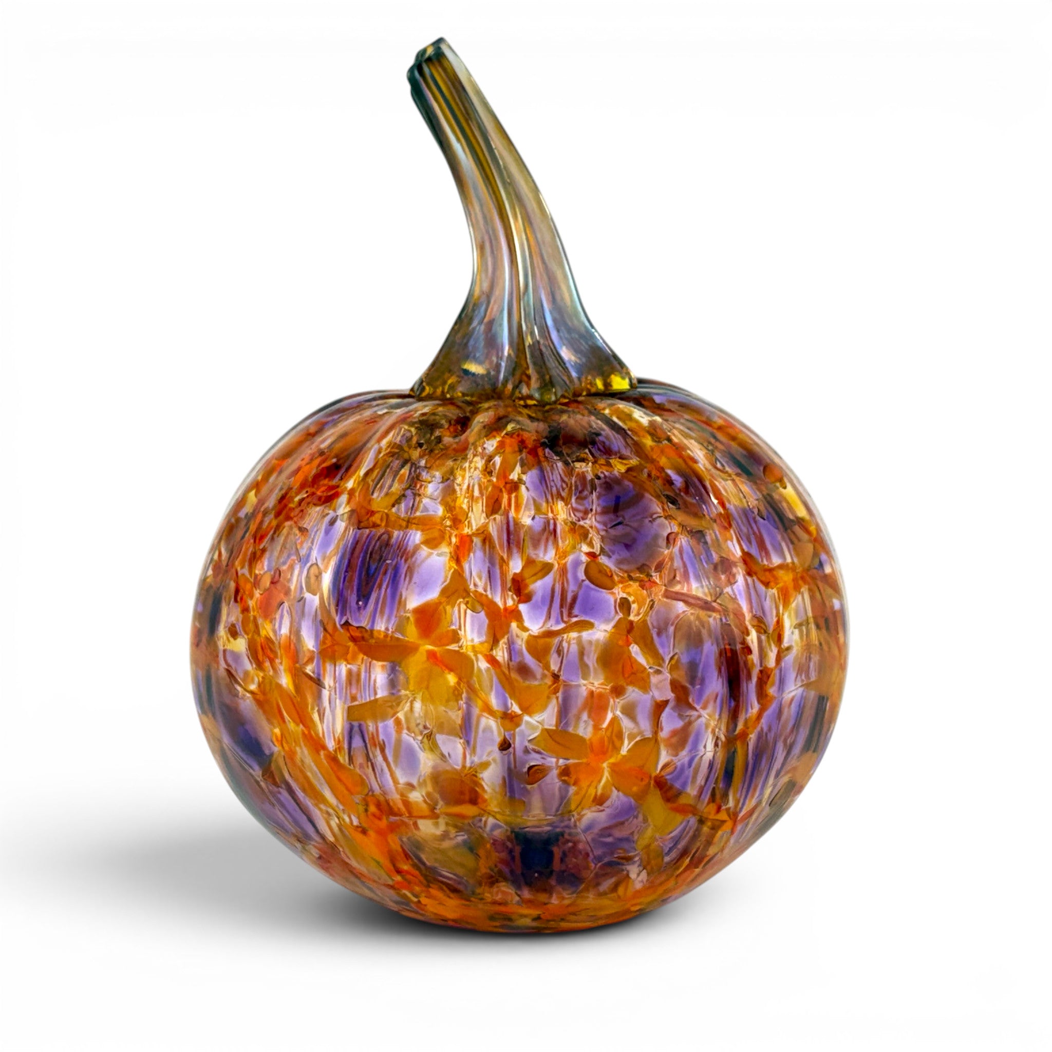 A hand-blown glass pumpkin with a rounded body featuring a marbled pattern of orange, purple, and amber tones, complete with a curved stem, shown on a white background.