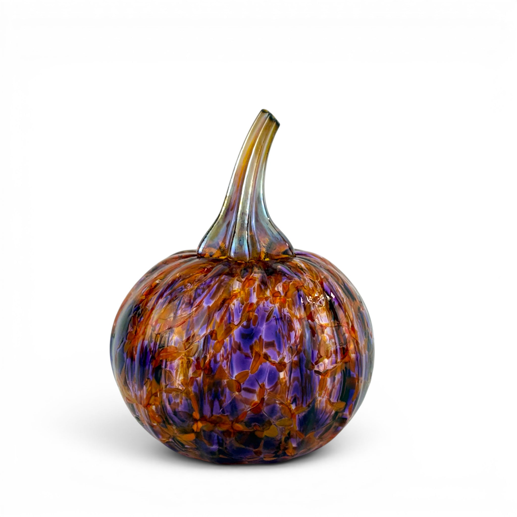 A hand-blown glass pumpkin with a textured, marbled pattern of amber orange, deep purple, and blue, featuring a curved glass stem, set against a plain white background.