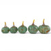 Five small decorative glass pumpkins in a row, made of speckled light green glass with yellow and orange accents on the stems, set against a plain white background.