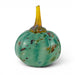 A decorative hand-blown glass pumpkin with a rounded teal-green body speckled with small brown and amber flecks, and a tall translucent amber-yellow stem, shown on a white background.