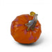 An orange glass pumpkin figurine with a curved amber and smoky brown stem, photographed on a clean white background.