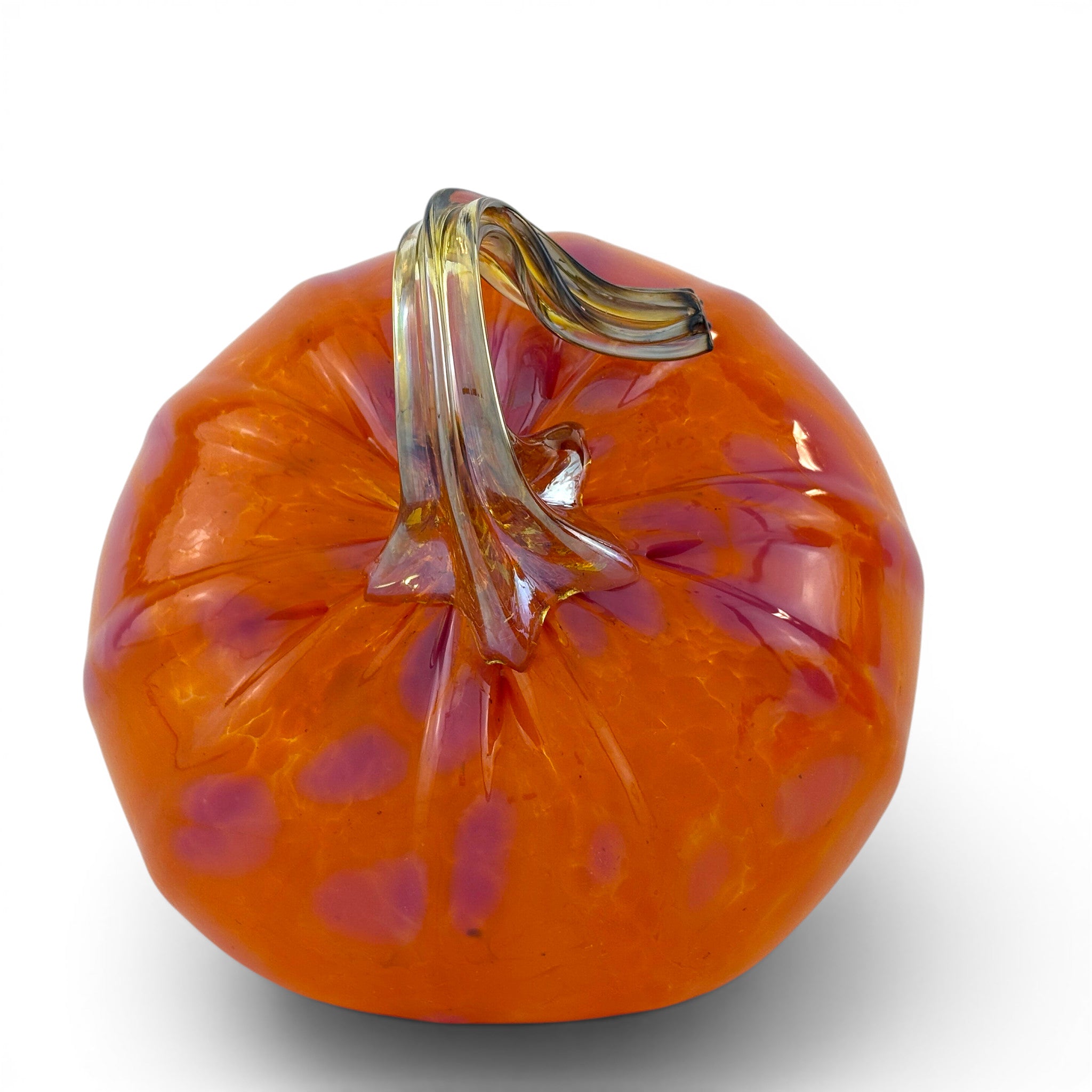 An orange glass pumpkin sculpture with purple speckles and a twisted clear glass stem, shown on a white background.