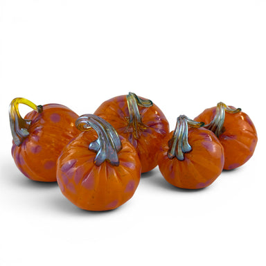 Five orange glass pumpkins with purple speckles and metallic silver-gray stems, arranged together on a white background.