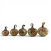 Five small decorative glass pumpkins arranged in ascending size order on a plain white background. The pumpkins have a warm beige base with orange and brown marbled speckles and metallic gold-toned loop handles.