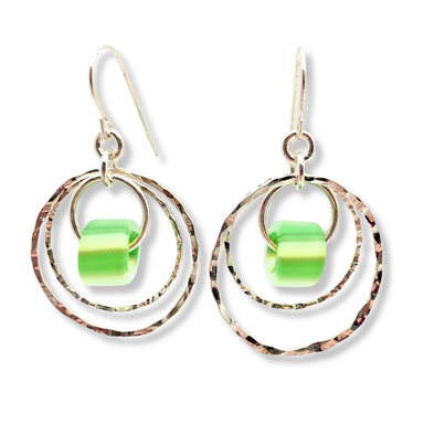 A pair of silver-colored double hoop earrings with blue glass beads attached to them.