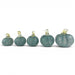 Five small decorative glass pumpkins arranged in ascending size on a plain white background. The pumpkins are made of textured, marbled teal-blue glass with pale yellow stems.