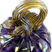 A close-up of a handcrafted glass pumpkin, featuring a twisted gold stem and a purple body with reflective metallic highlights.   