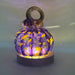 A handcrafted glass pumpkin with a loop stem, illuminated from within by an LED display light with a round wooden base.  