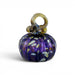 A hand-blown glass pumpkin with a deep purple body, white and yellow flecks, and a twisted amber-yellow stem.  
