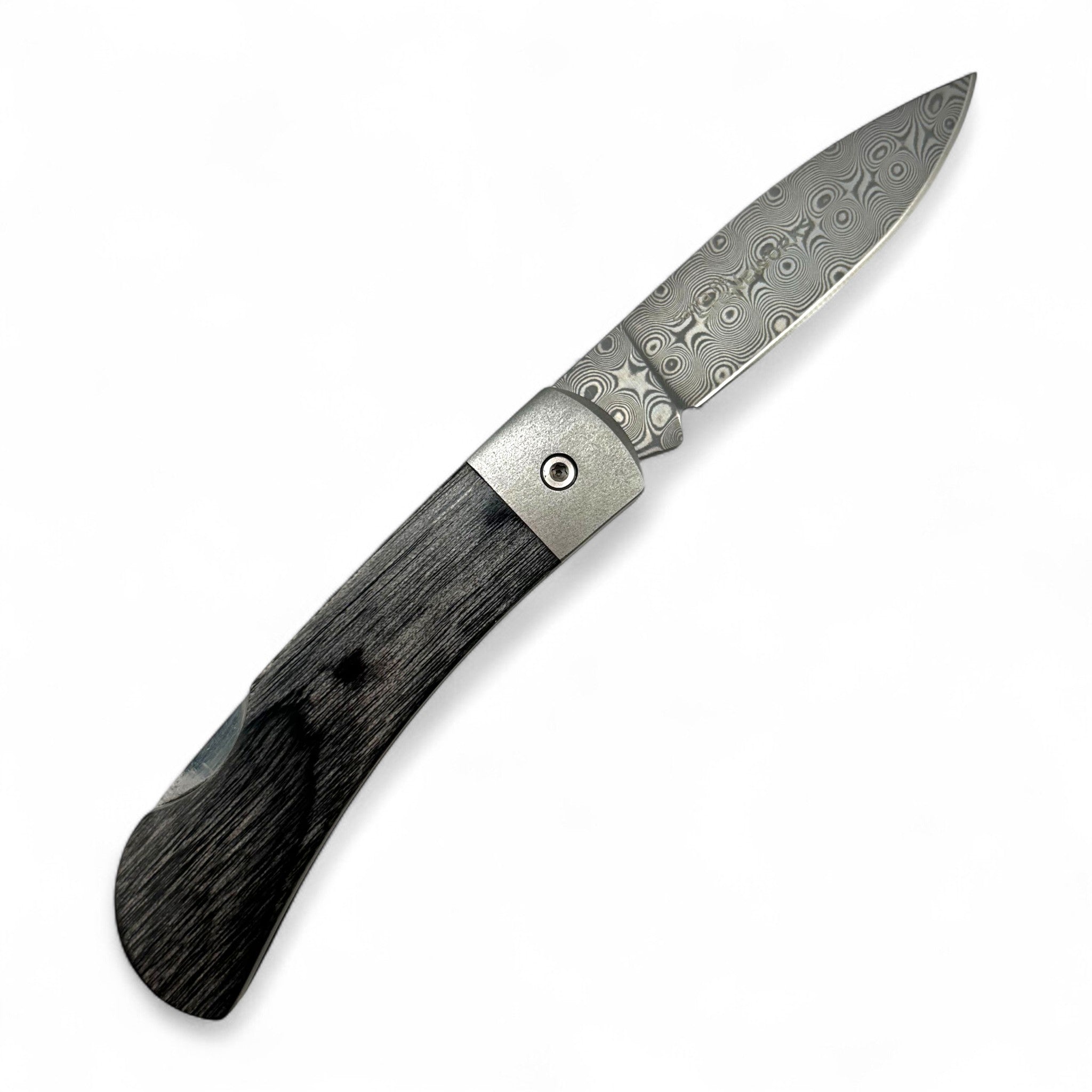 Folding knife with decorative blade and wooden handle on a white background