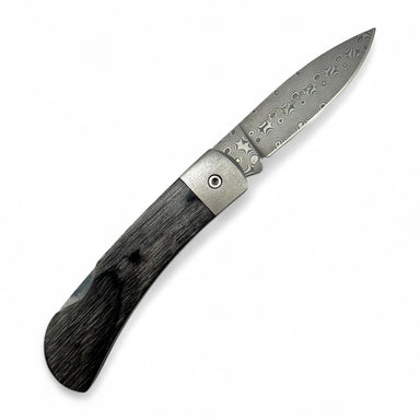 Folding knife with decorative blade and wooden handle on a white background
