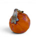 An orange glass pumpkin figurine with a glossy finish and a textured, iridescent silver-gray stem, shown on a clean white background.