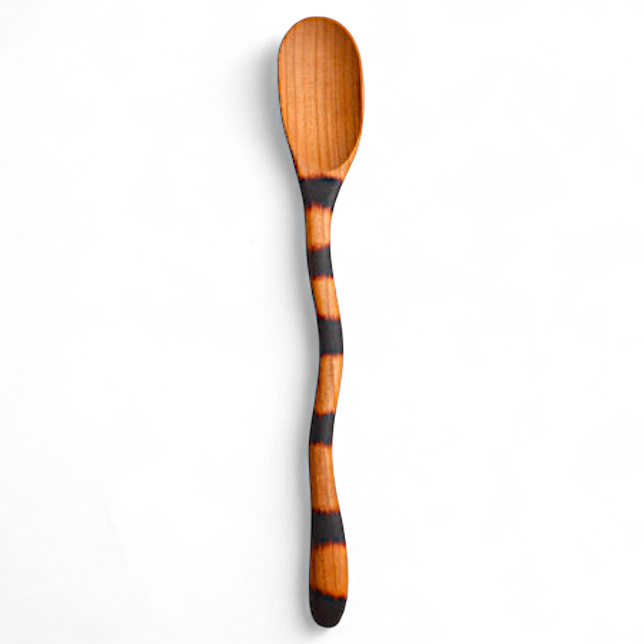 wooden spoon with black band on a white background