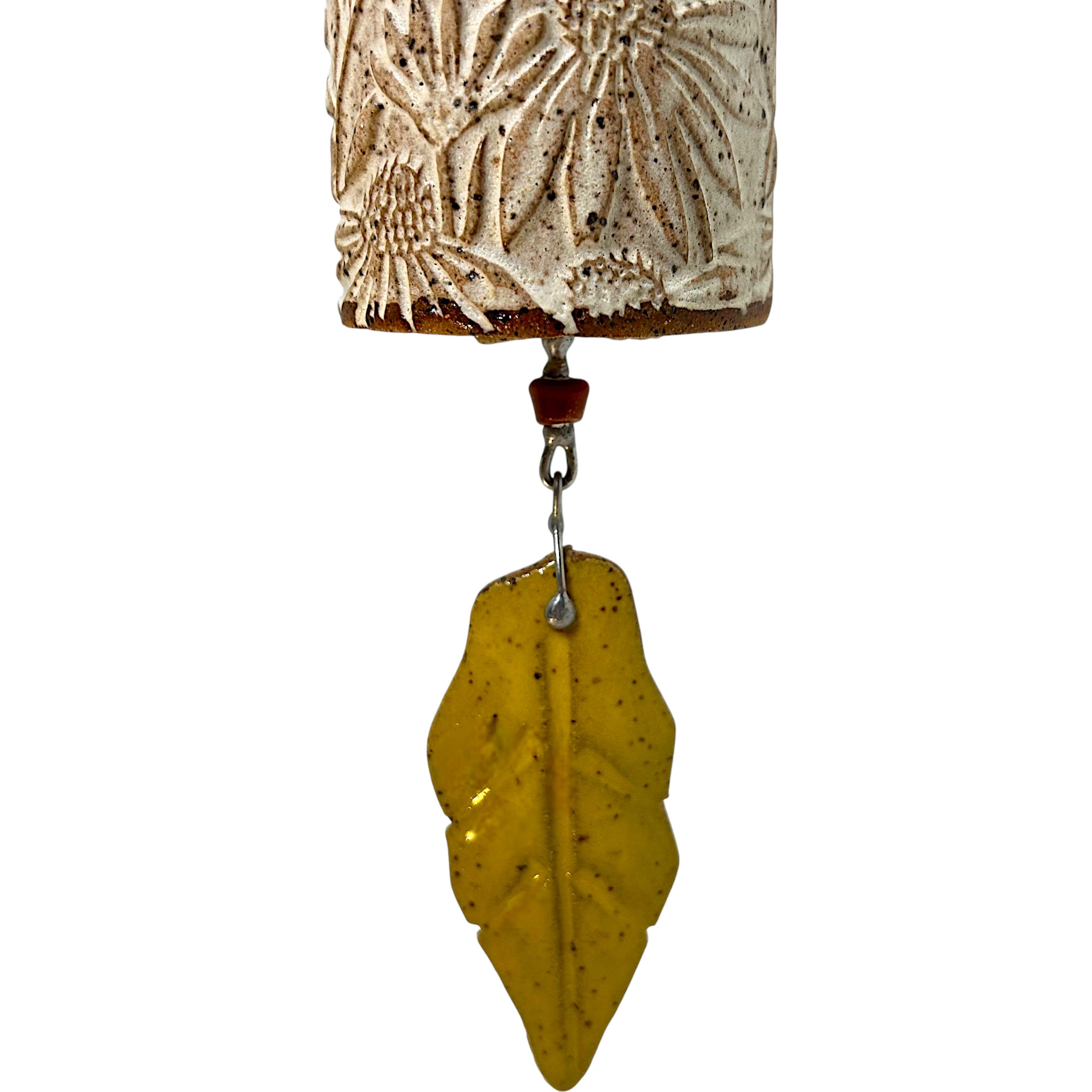Decorative ceramic bell with textured cone flower pattern and yellow leaf bell clapper 