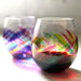 Two colorful stemless wine glasses on a white background
