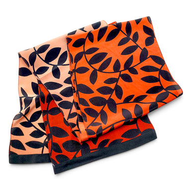 Three-fold square scarf with a black leaf vine pattern, displayed on a solid white background. 