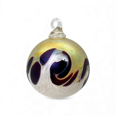 Decorative glass ornament with magenta and gold swirls on a white background