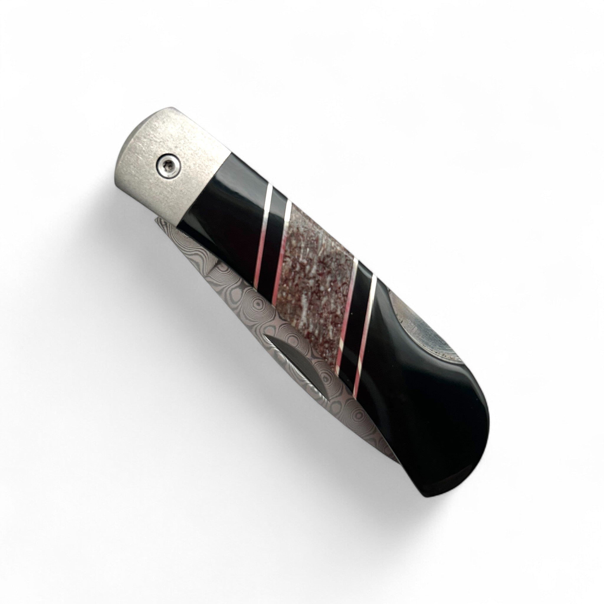 Folding knife with black and silver design on a white background