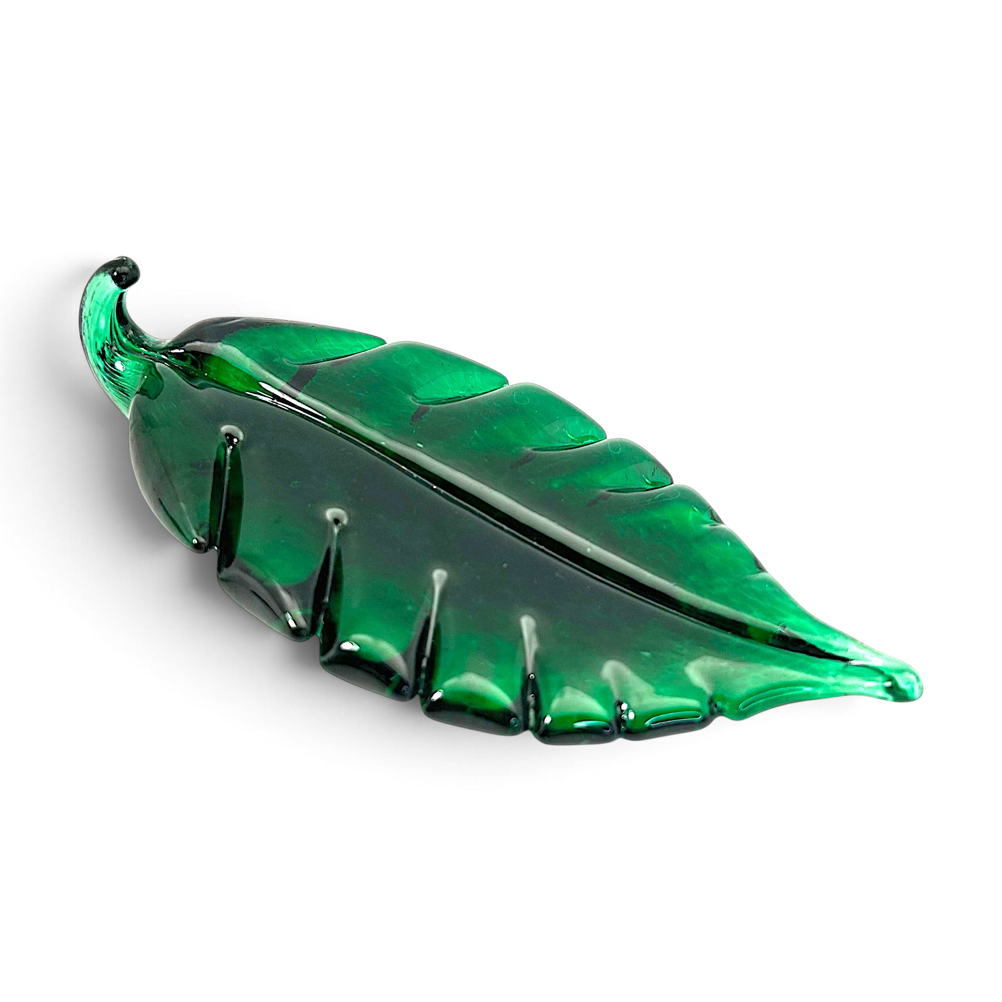 A handcrafted, translucent emerald green glass leaf sculpture.  