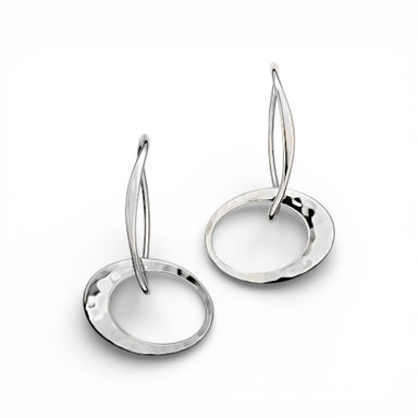 A pair of silver elliptical earrings with a long tapered silver ear wire, hand-hammered sterling ellipses