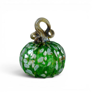 A handcrafted green glass pumpkin with a textured ribbed body, white and light green leaf-like inclusions, and a twisted stem loop. 