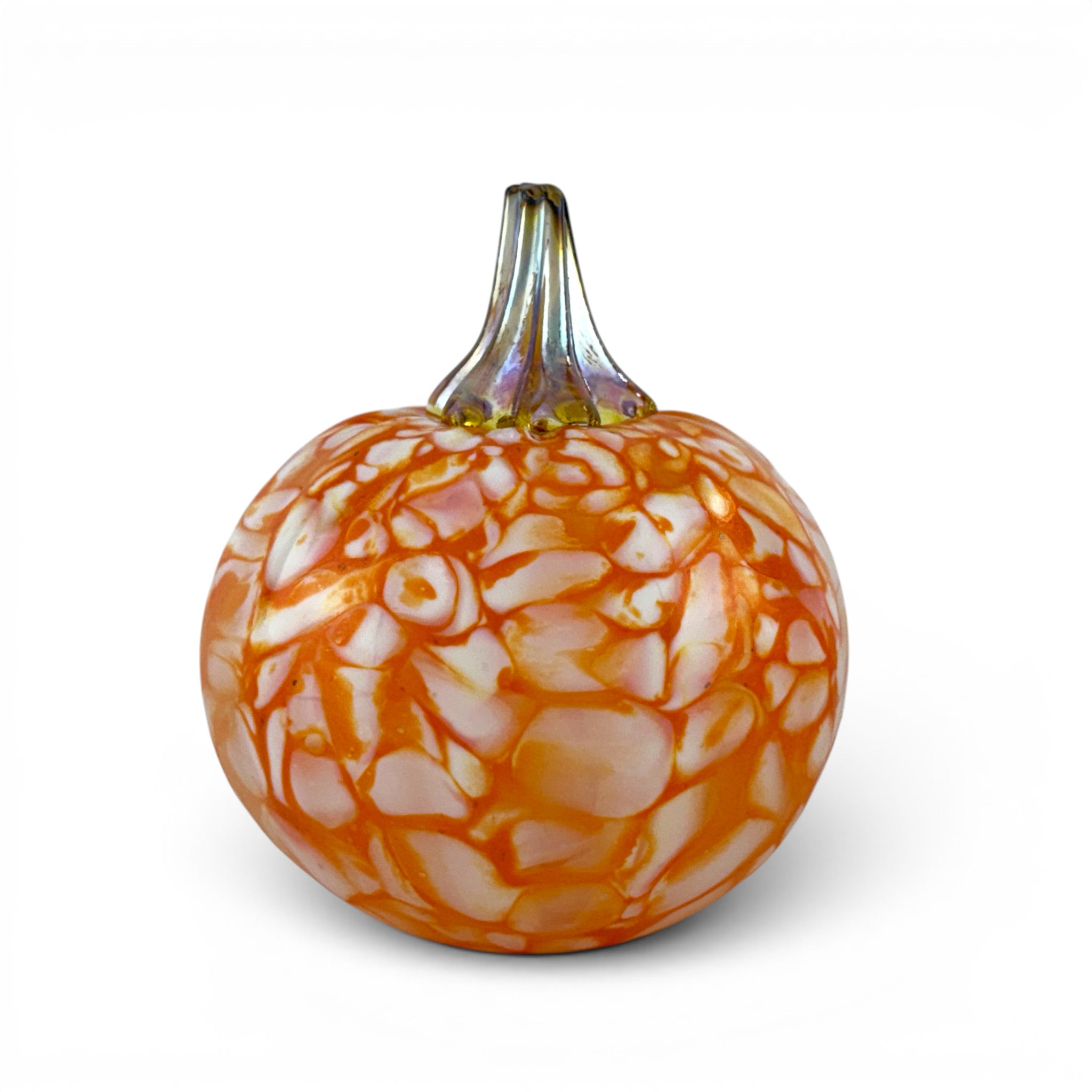 An orange and white marbled glass pumpkin with a textured, stone-like pattern and a short iridescent stem, shown on a clean white background.