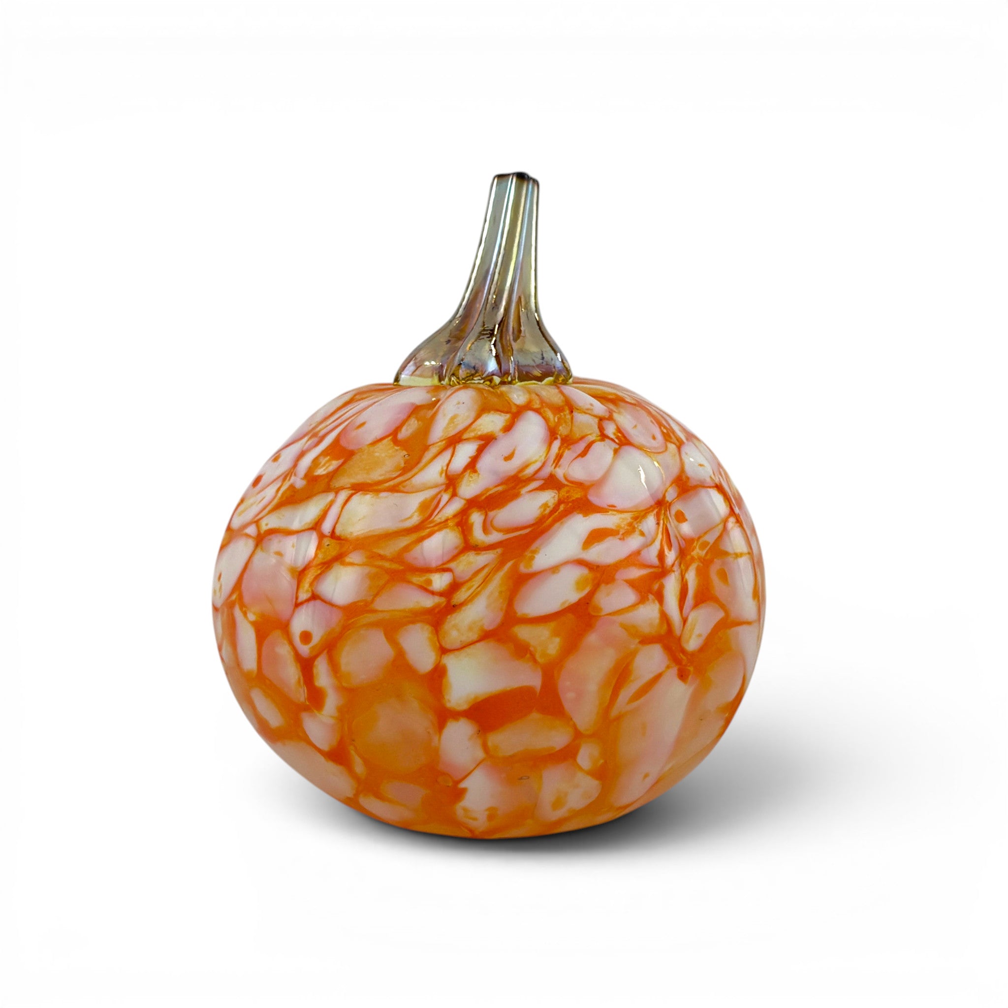 A decorative glass pumpkin with a textured, marbled pattern of orange and white, featuring a clear glass stem, set against a plain white background.