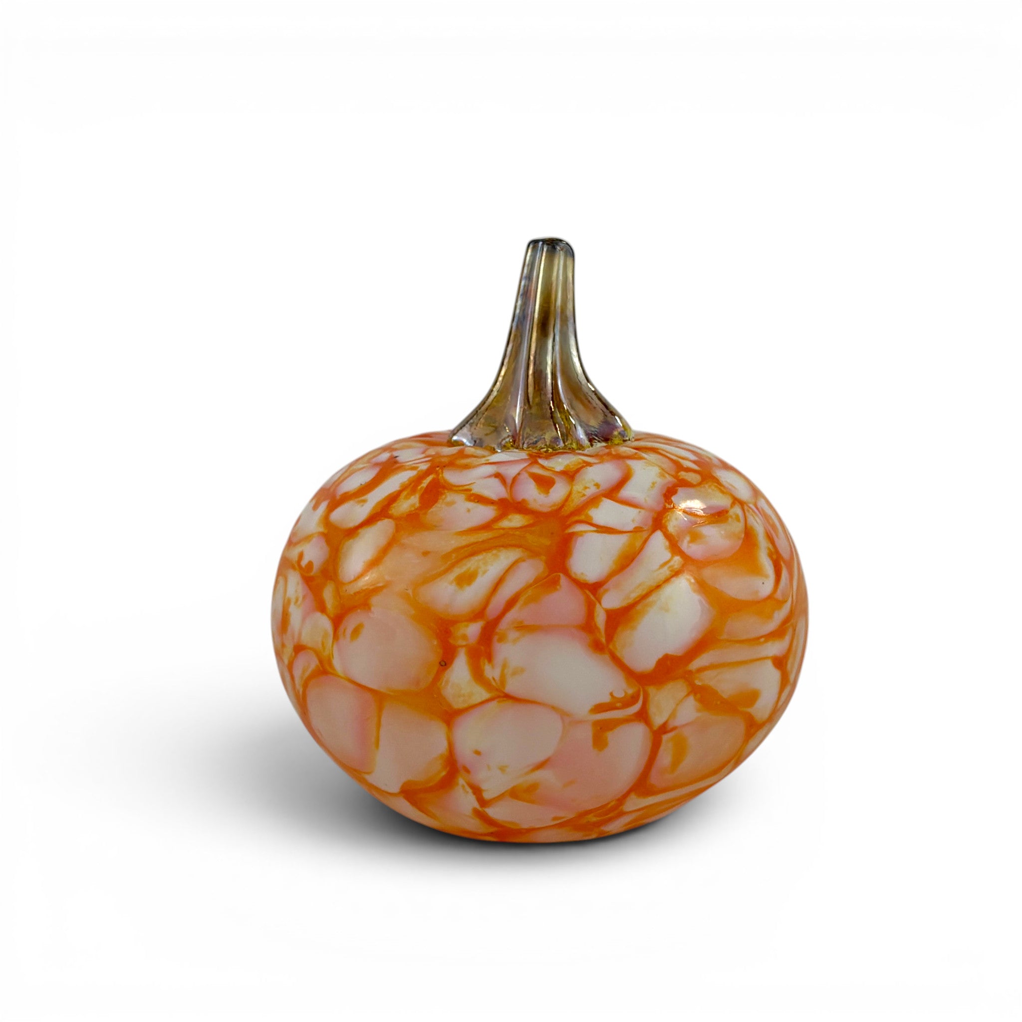 A decorative glass pumpkin with a textured, crackled pattern in orange and white, featuring a short, ribbed glass stem, set against a plain white background.
