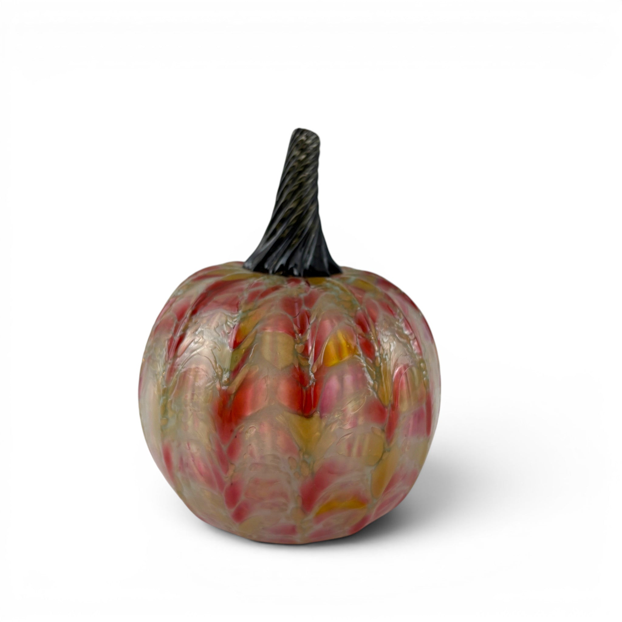 A handcrafted glass pumpkin with a marbled pattern of red, pink, yellow, and clear glass, featuring a textured dark green stem. 
