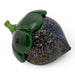 A decorative handcrafted glass acorn sculpture featuring a glossy dark green cap and stem with a mottled body with blue, brown, and gold flecks. 
