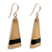 A pair of earrings featuring a geometric carved design with a gold-tone finish and black resin accents on the hooks.