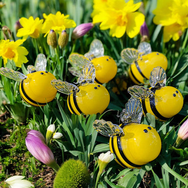 group of handcrafted glass bees nestled in crocus blooms make us think of spring