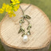 Bring in spring with this handcrafted vine and pearl design-forward pendant and necklace