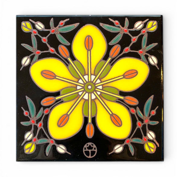 Decorative hand-glazed art  tile with a yellow flower creosote bush design on a black background