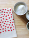 Strawberry hand-printed cotton kitchen towel is a colorful kitchen addition 