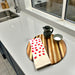 Hand-printed strawberry motif kitchen towel brings a pop of color to kitchen decor