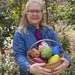 Lisa Oakley hold a basket of hand-blown glass eggs that will be auctioned and raffled for the Food Bank of Central and Eastern NC