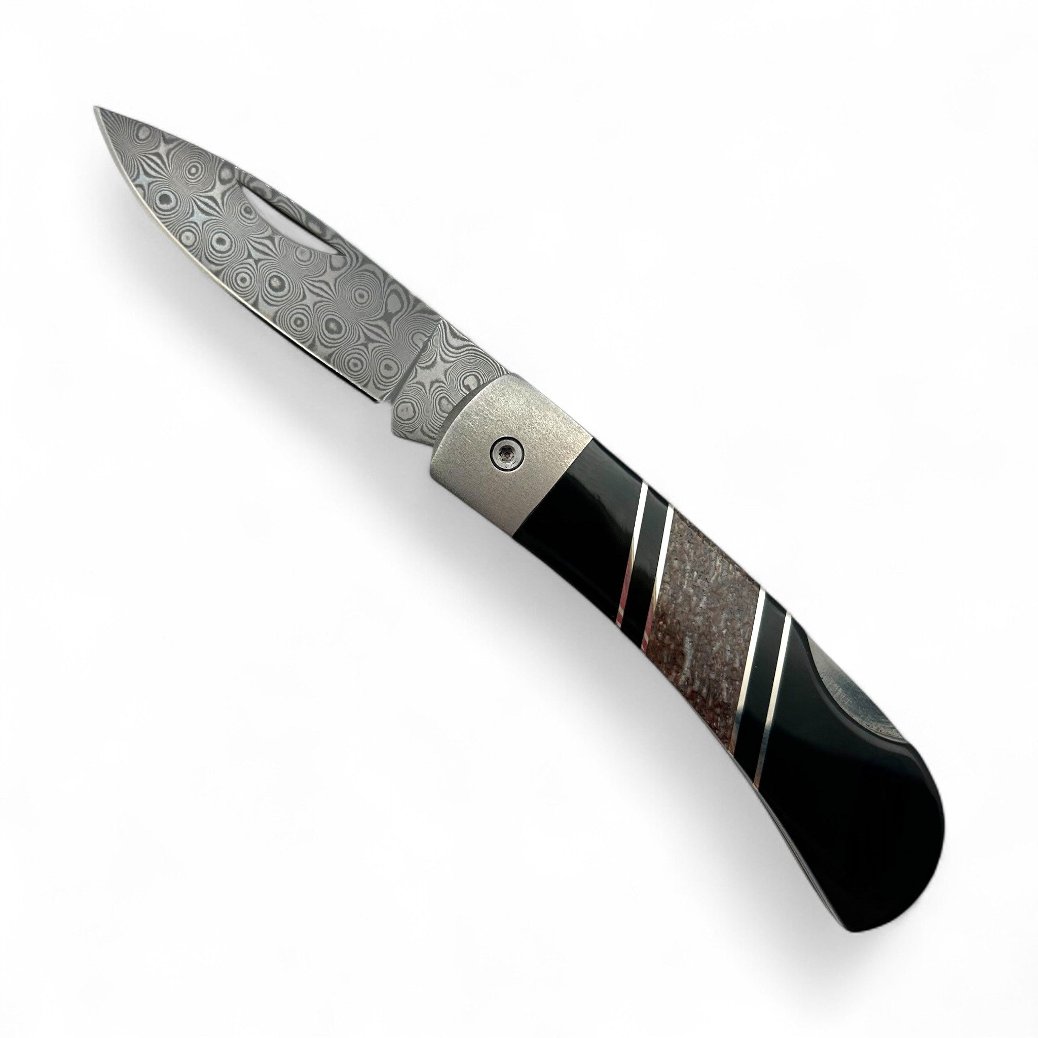 Folding knife with decorative blade and handle on a white background