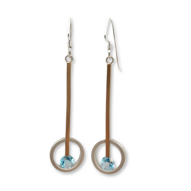 A pair of silver and gold fill earrings with blue topaz accents, displayed against a white background.