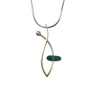 A sea glass necklace with a contemporary design, featuring a brushed sterling silver chain, a gold fill pendant, and a pearl accent.