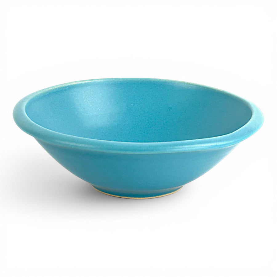 handcrafted blue ceramic bowl has a blueberry design in the center