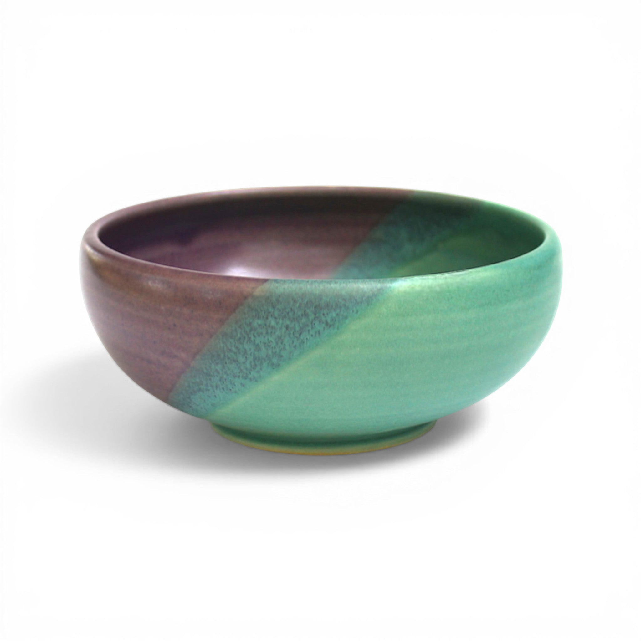 Ceramic bowl with purple and green gradient on a white background