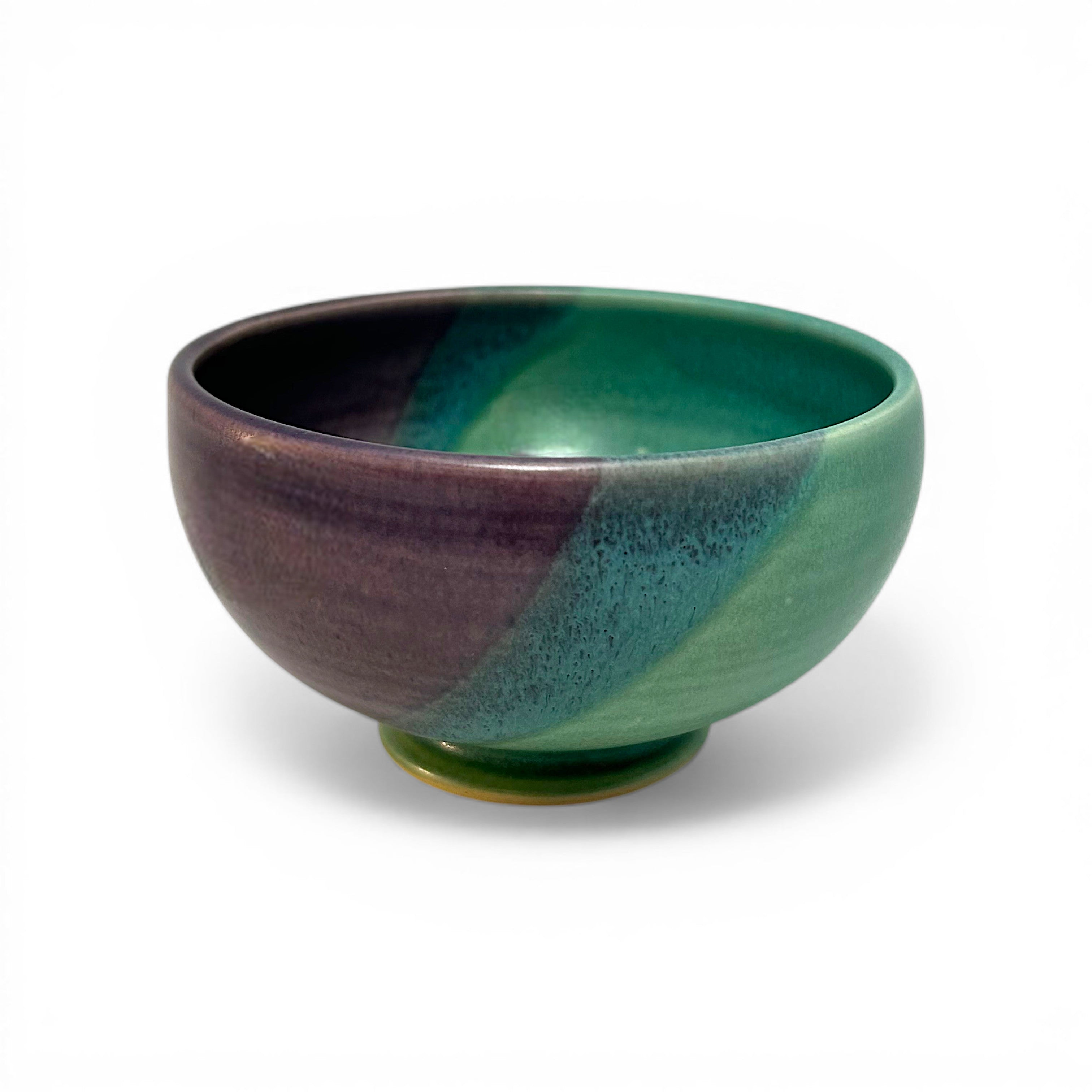 Ceramic bowl with green and purple gradient on a white background