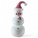 Three-tiered snowman figurine with a pink hat and red ribbon on a white background