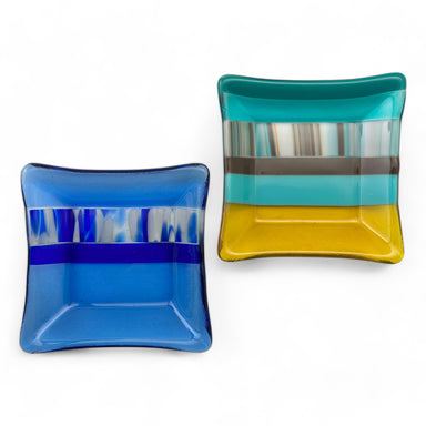 Two decorative glass dishes, one with blue stripes and the other with yellow stripes.