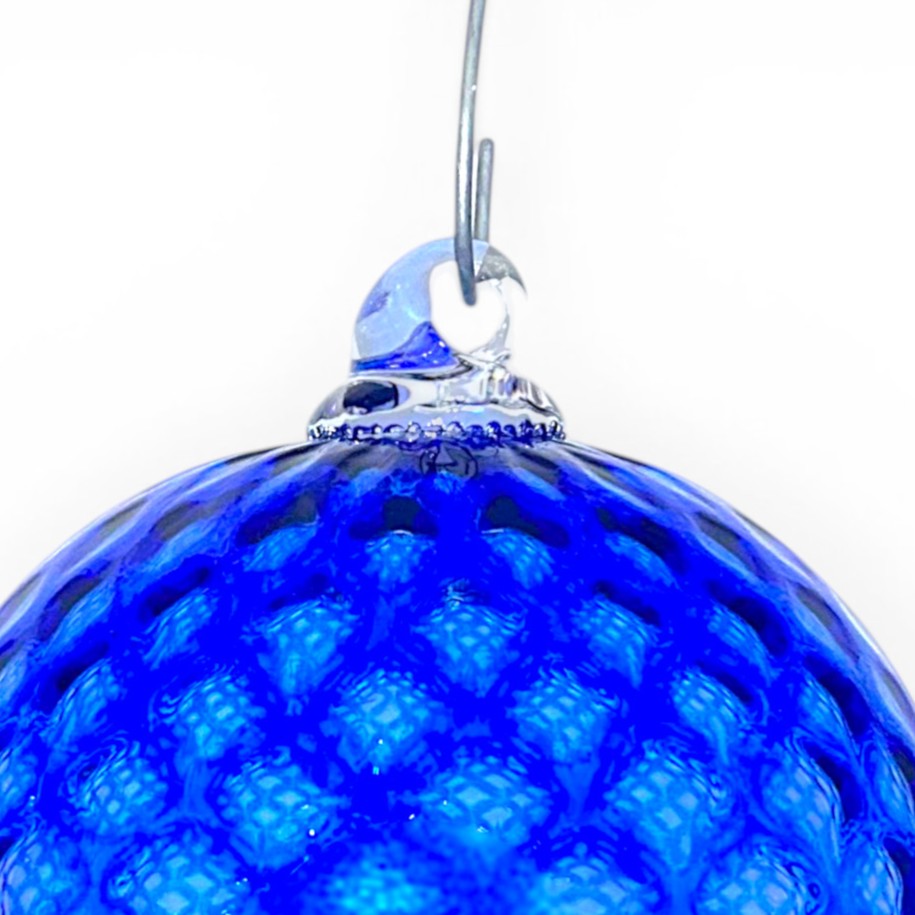 Close-up of a blue textured handblown glass infinity globe with a glass hanging hook.
