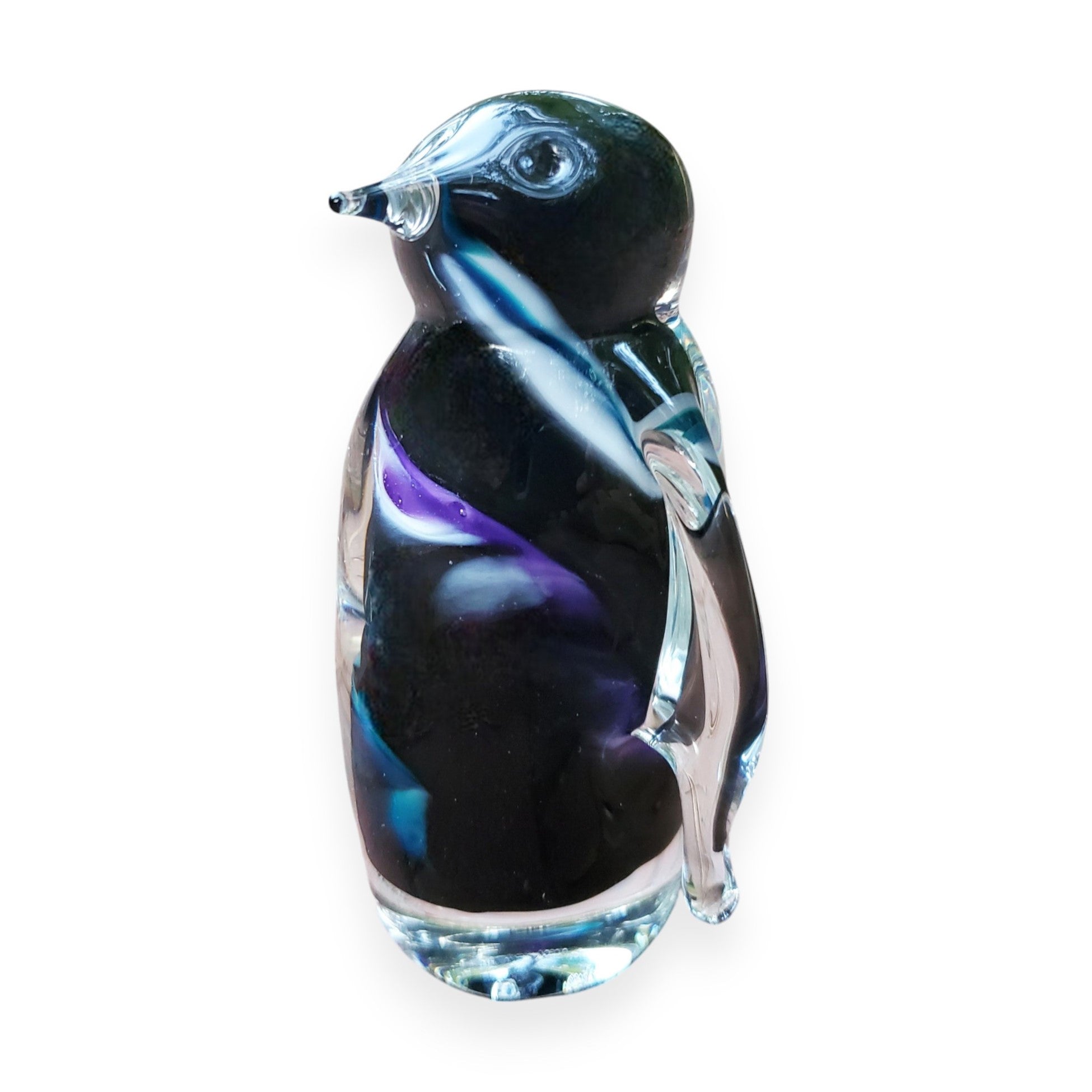 A hand-crafted glass figurine of a penguin with a black body and multicolored head and neck.