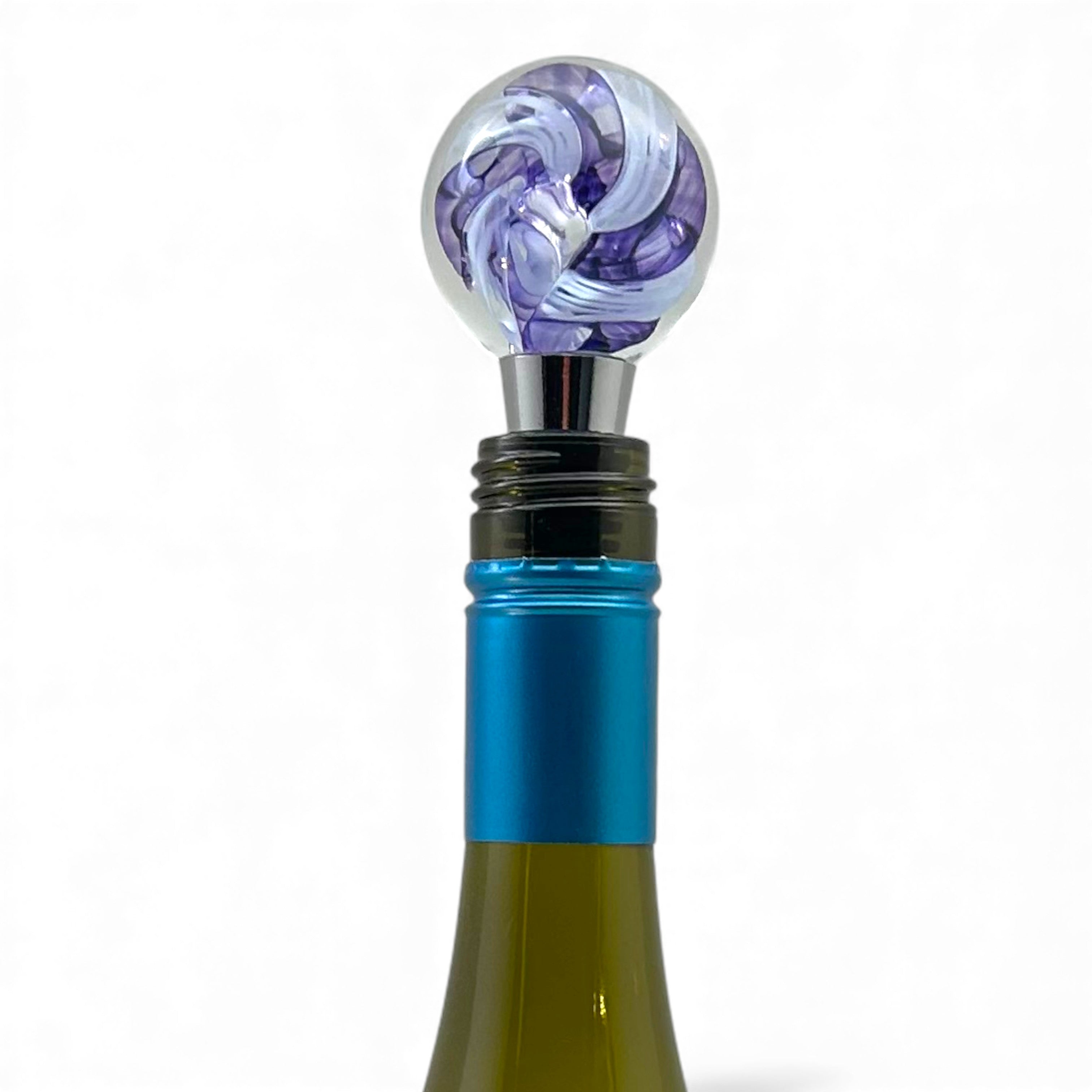 Wine bottle stopper with purple and blue design on a white background