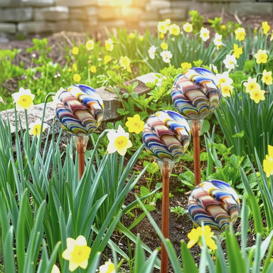 Handcrafted colorful glass garden balls are wonderful additions to a spring garden